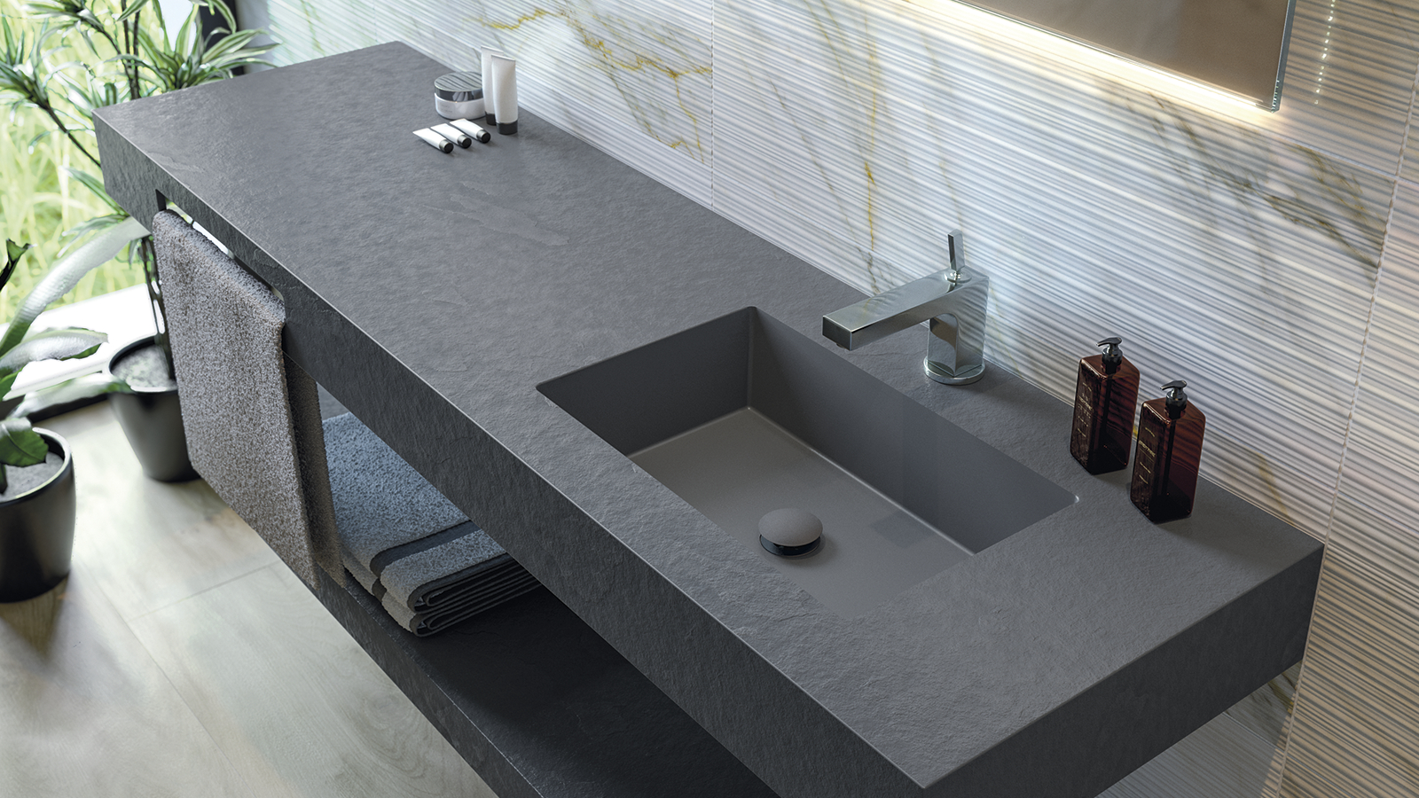 Plan vasque en pierre sombre, mitigeur chrome et mur relief